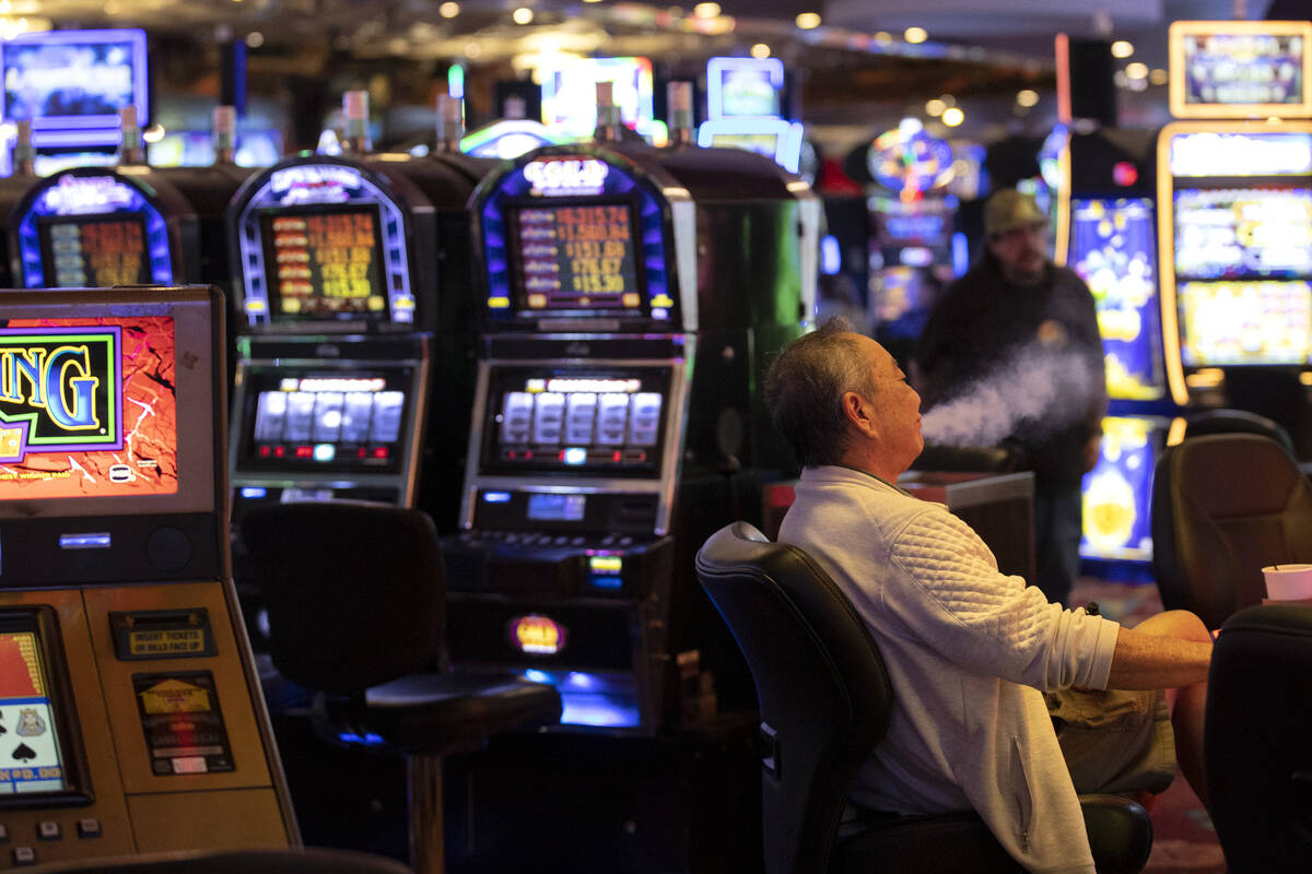 Darryl Fujihara, of Las Vegas, vapes while gambling at The Plaza on Thursday, March 2, 2023, in ...