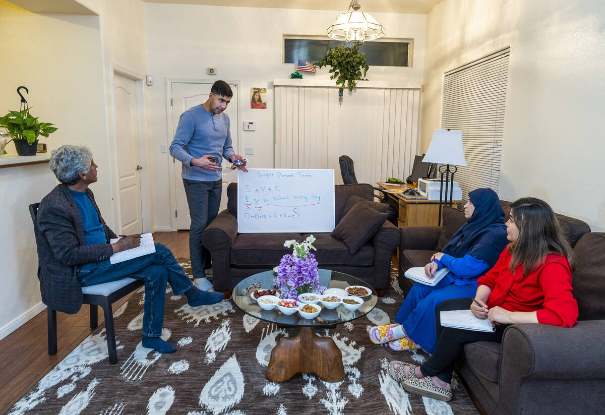 Abdul looks to son Mohammad "Benny" Shirzad as he teaches English to his mother, Nazanin, and w ...