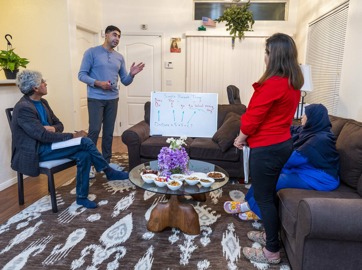Abdul looks to son Mohammad "Benny" Shirzad as he teaches English to his wife, Shabana, and mot ...