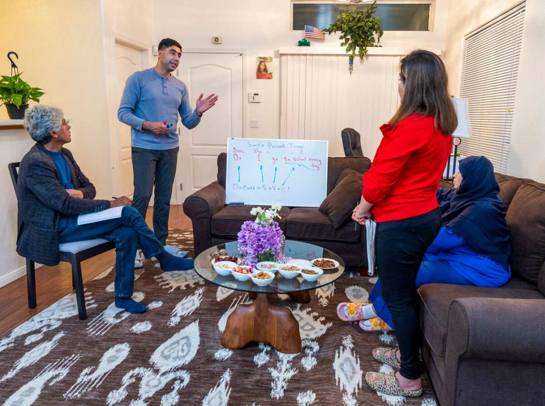 Abdul looks to son Mohammad "Benny" Shirzad as he teaches English to his wife, Shabana, and mot ...
