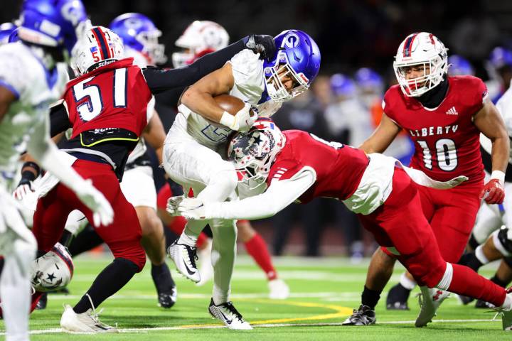 Bishop Gorman's Micah Kaapana (22) is tackled by Liberty after a run during the first half of t ...