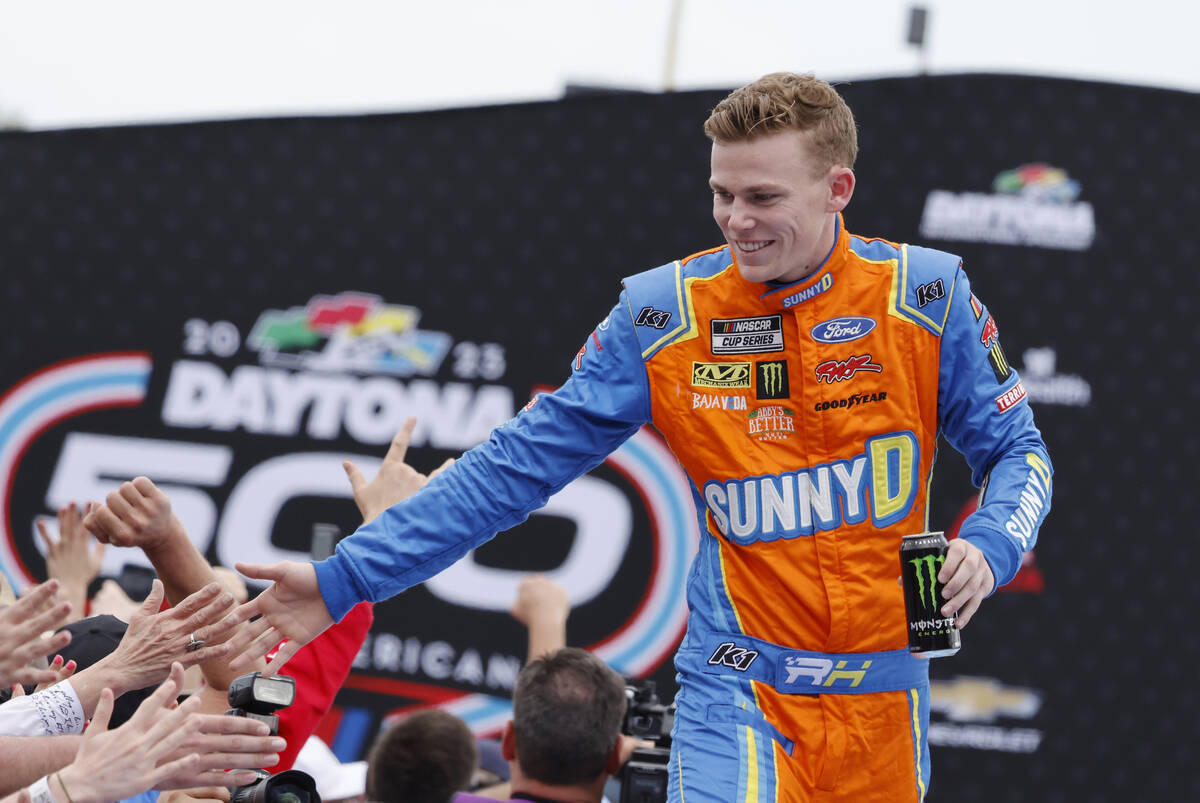 Riley Herbst greets fans during driver introductions before the NASCAR Daytona 500 auto race at ...