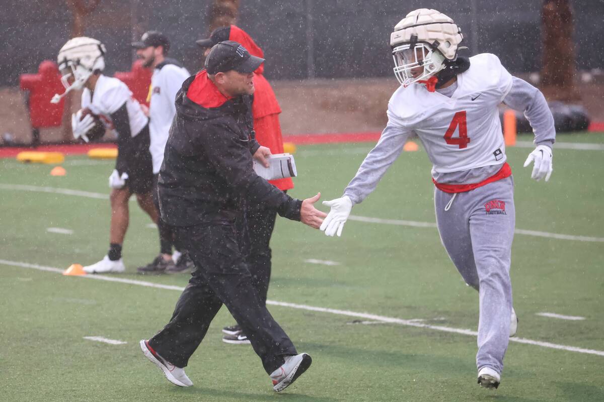 UNLV head coach Barry Odom greets UNLV defensive back Jerrae Williams (4) during the first day ...