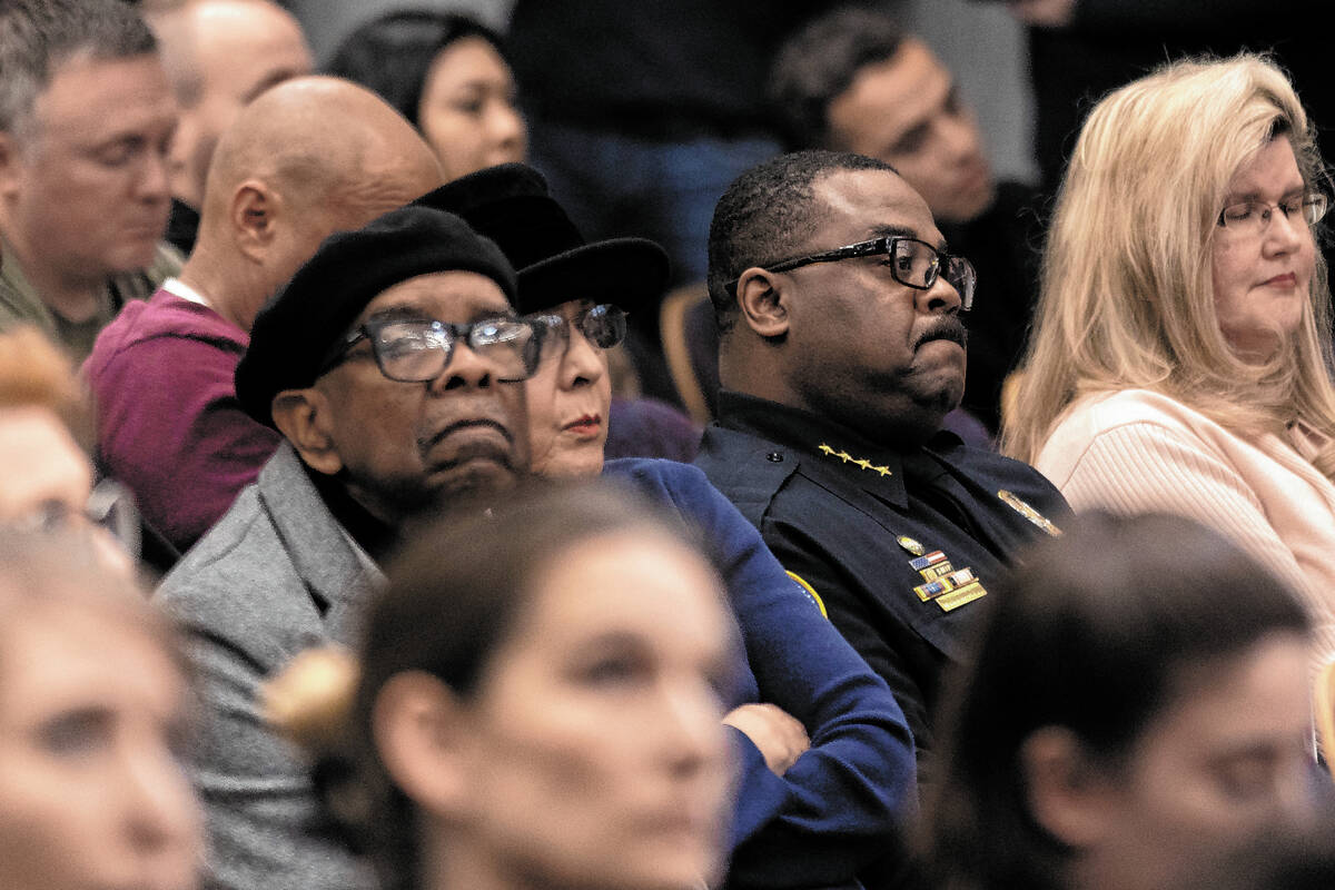 Henderson Chief of Police Thedrick Andres, second from right, listens to public commentary duri ...