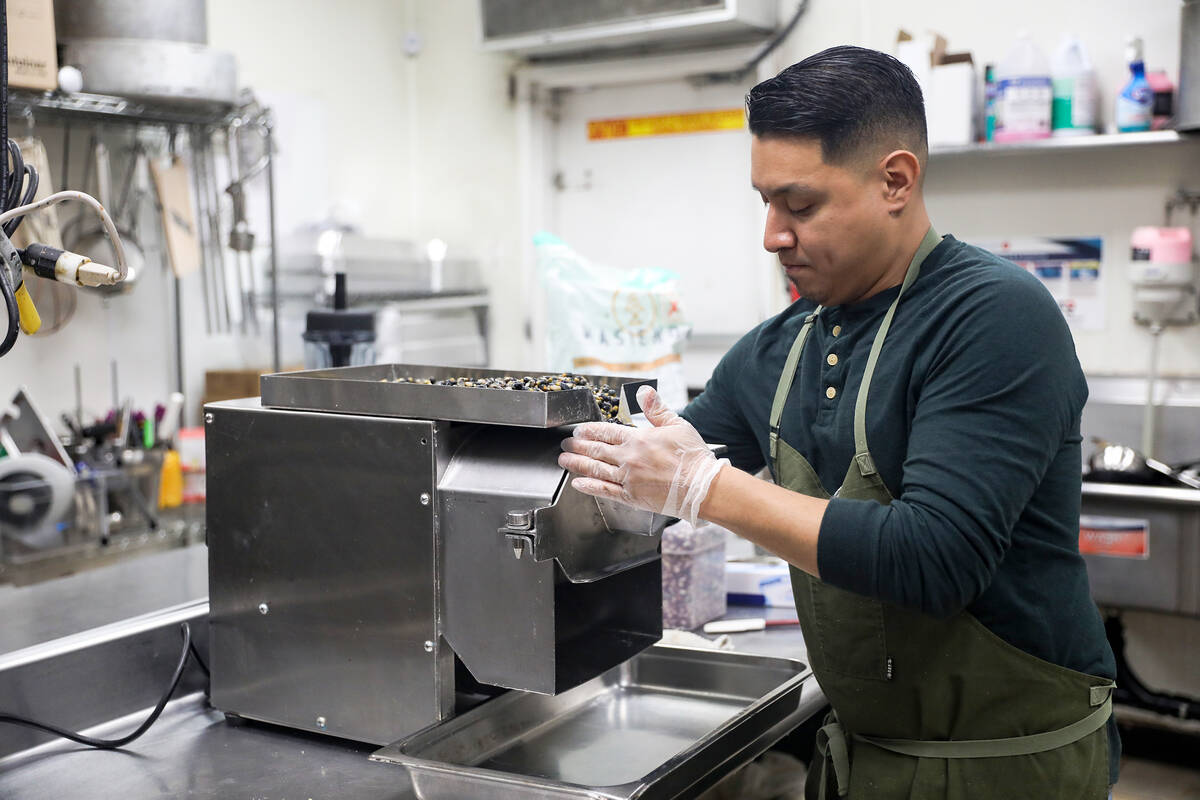 Chef DJ Flores grinds corn kernels to create masa at Milpa, his Mexican restaurant in the south ...