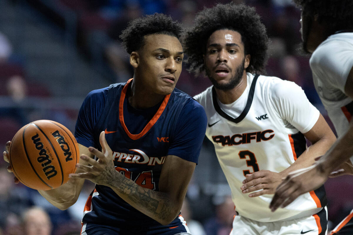 Pepperdine forward Maxwell Lewis (24), who is from Las Vegas, drives past Pacific guard Tyler B ...
