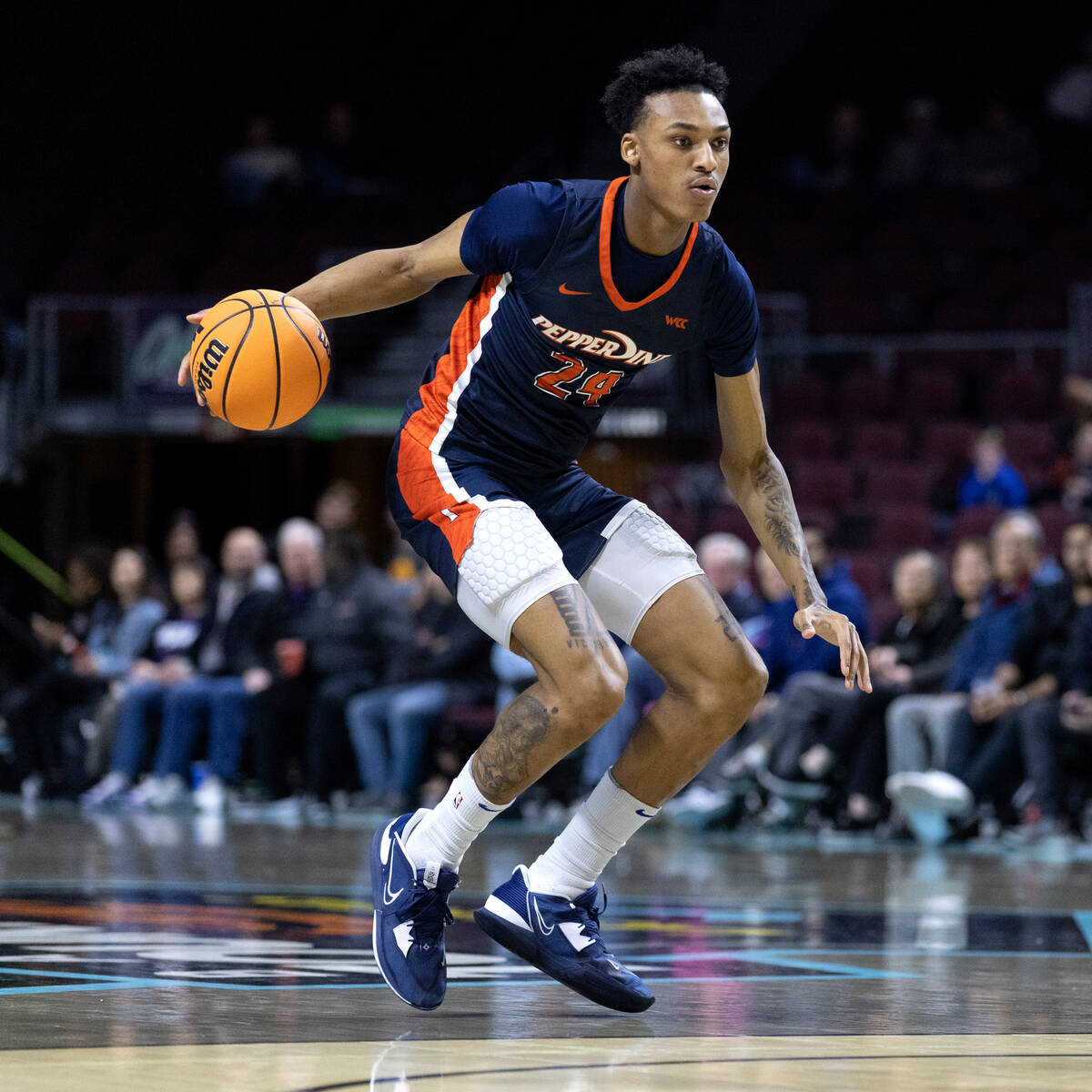 Pepperdine forward Maxwell Lewis (24), who is from Las Vegas, dribbles up the court during a We ...