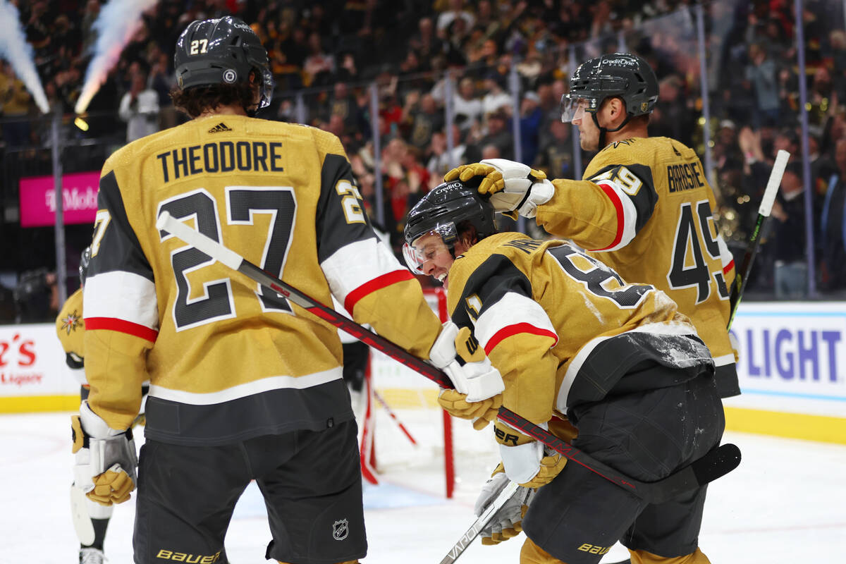 Vegas Golden Knights right wing Jonathan Marchessault (81) celebrates his goal with defenseman ...