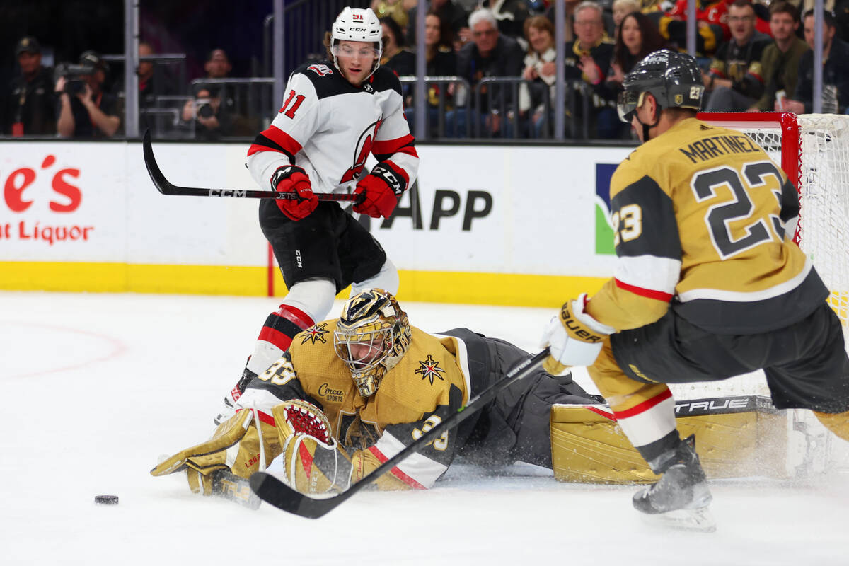 Vegas Golden Knights goaltender Adin Hill (33) stops a shot at the goal by New Jersey Devils ce ...