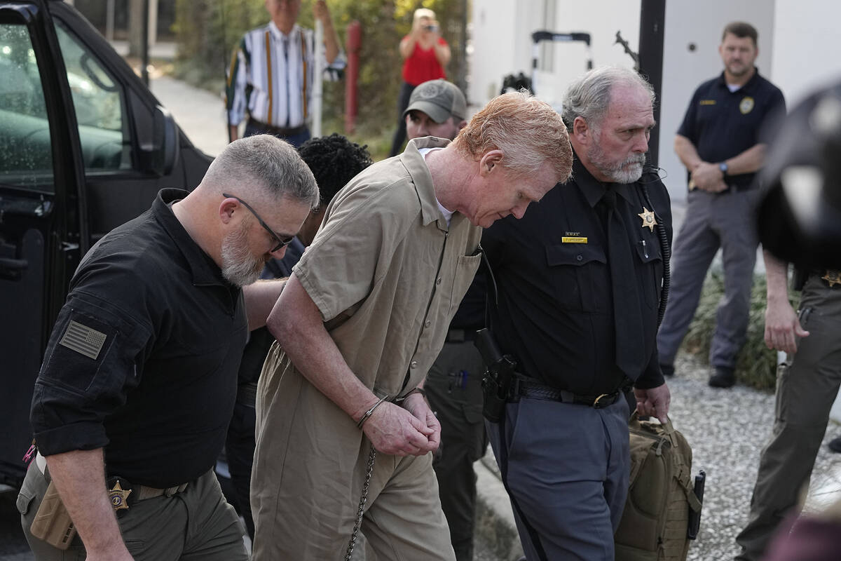 Alex Murdaugh is led to the Colleton County Courthouse by sheriff's deputies for sentencing Fri ...