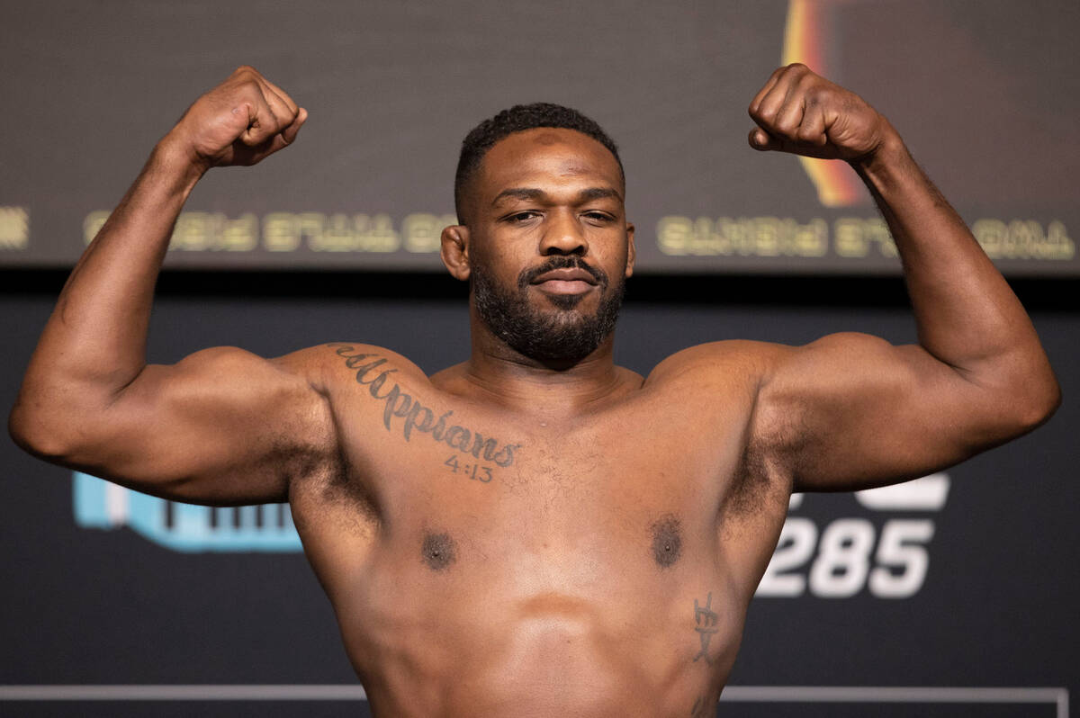 UFC heavyweight Jon Jones flexes on the scale for his weigh-in at the UFC Apex in Las Vegas on ...