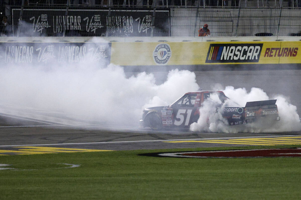 Kyle Busch (51) does a burnout after winning the Craftsman Truck Series auto race at Las Vegas ...