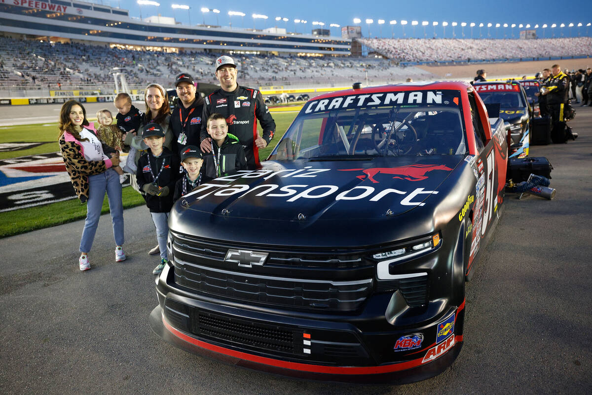 Kyle Busch (51), right, poses for a photo before the NASCAR Craftsman Truck Series auto race at ...