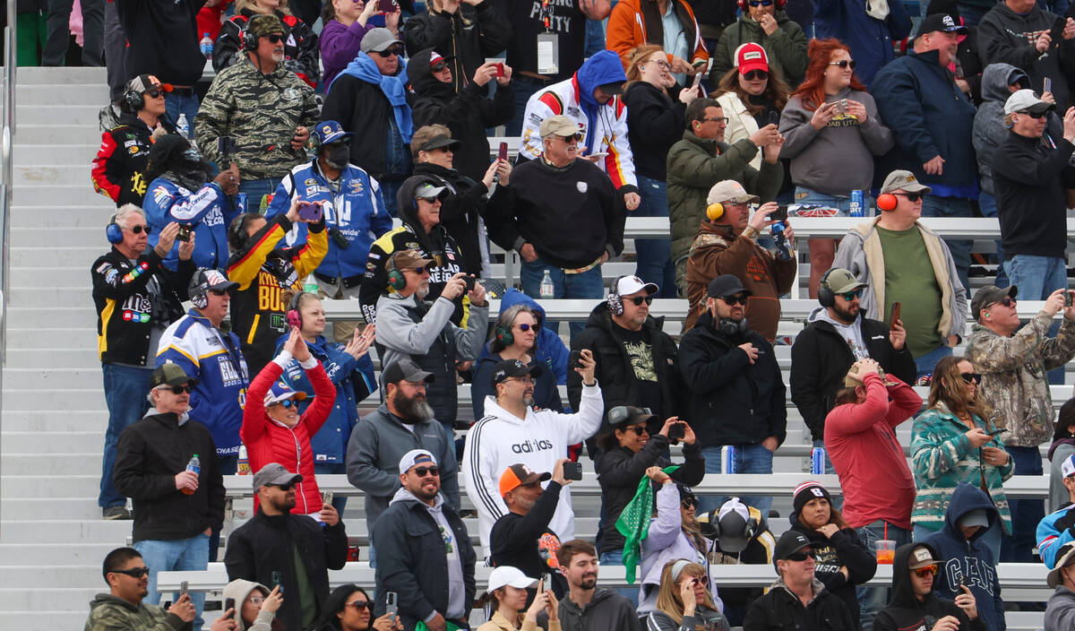 Fans react as the green flag is waved to signal the start of the Pennzoil 400 NASCAR Cup Series ...