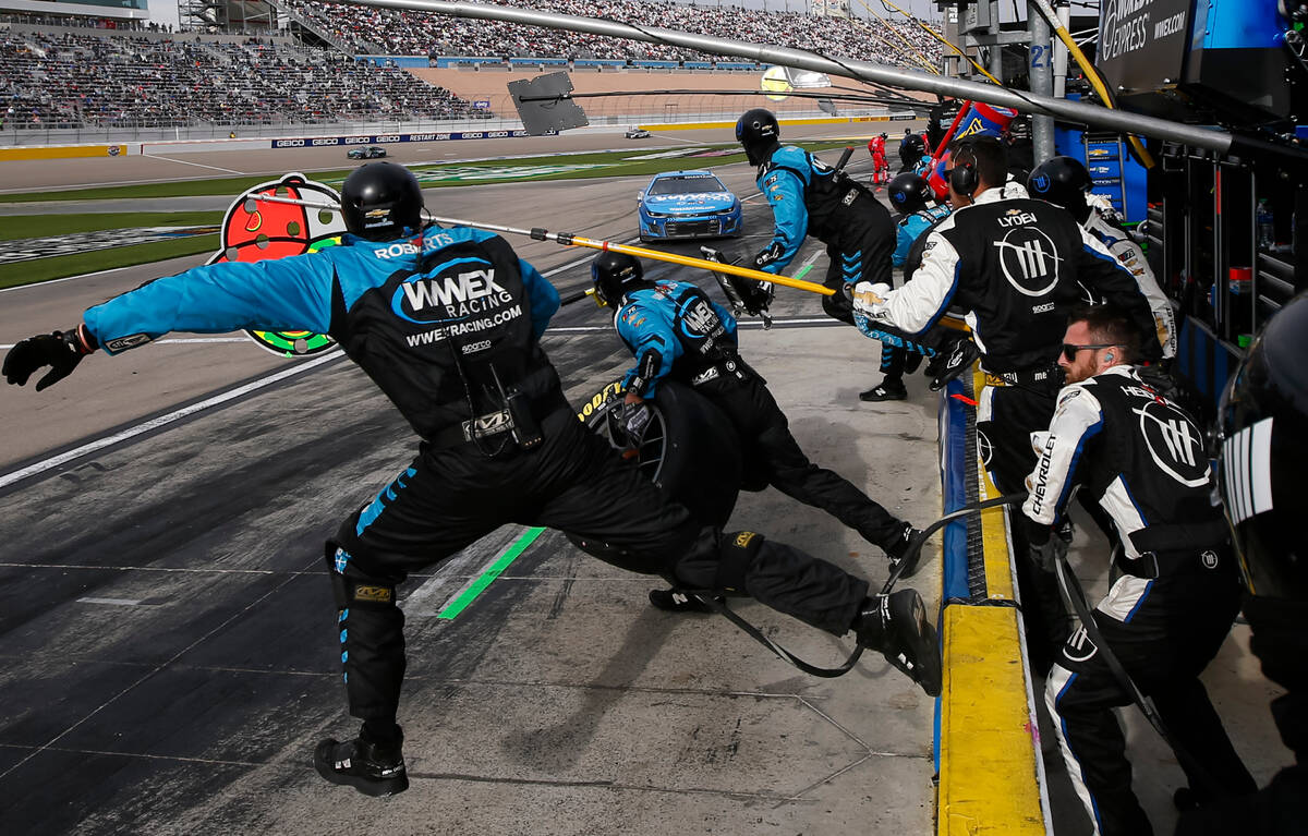 Pit crew members for driver Ross Chastain (1) leap onto pit road during the Pennzoil 400 NASCAR ...