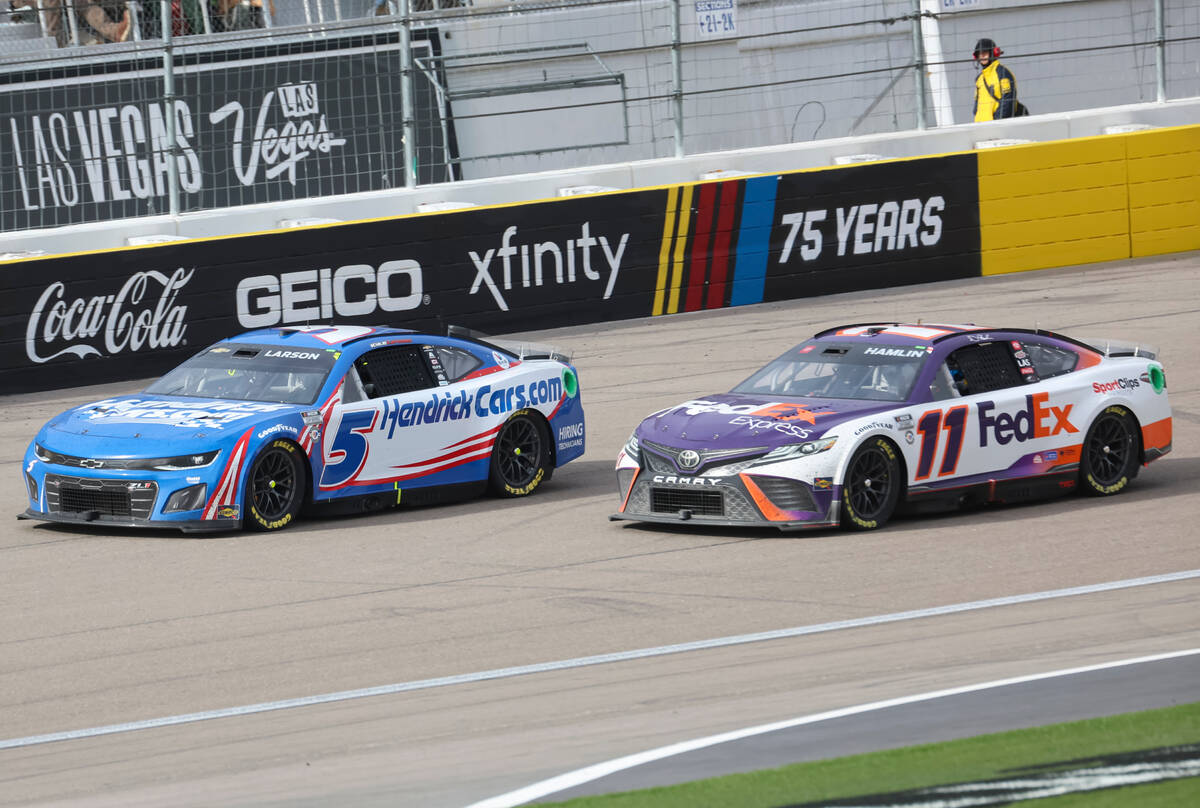 Driver Kyle Larson (5) overtakes Denny Hamlin (11) during the Pennzoil 400 NASCAR Cup Series ra ...