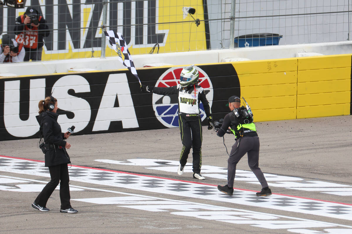 Driver William Byron waves the checkered flag after winning the Pennzoil 400 NASCAR Cup Series ...