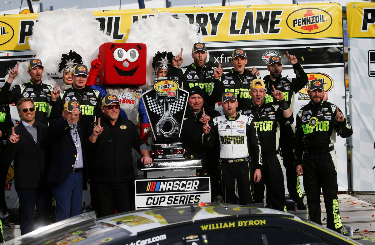 Driver William Byron, to the right of the trophy, poses for a picture after winning the Pennzoi ...