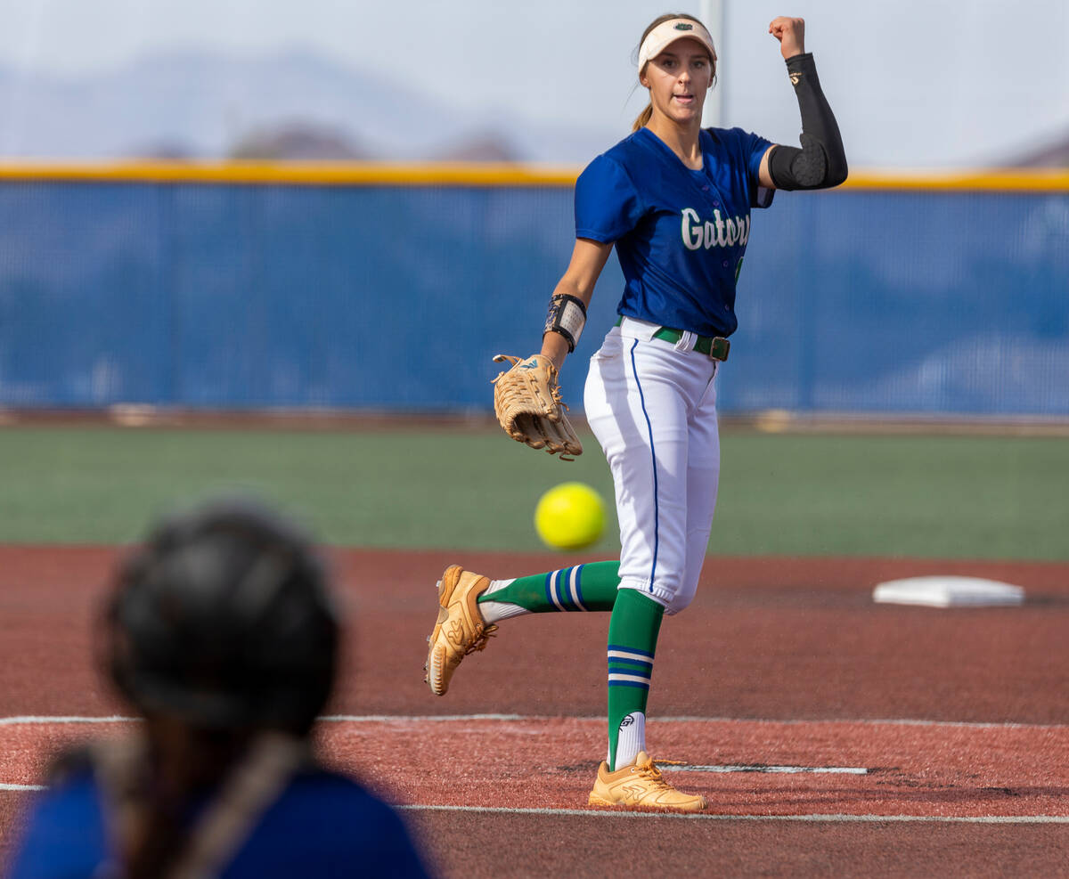 Green Valley pitcher Avari Morris (11) tosses another pitch to the plate and a Douglas player ...