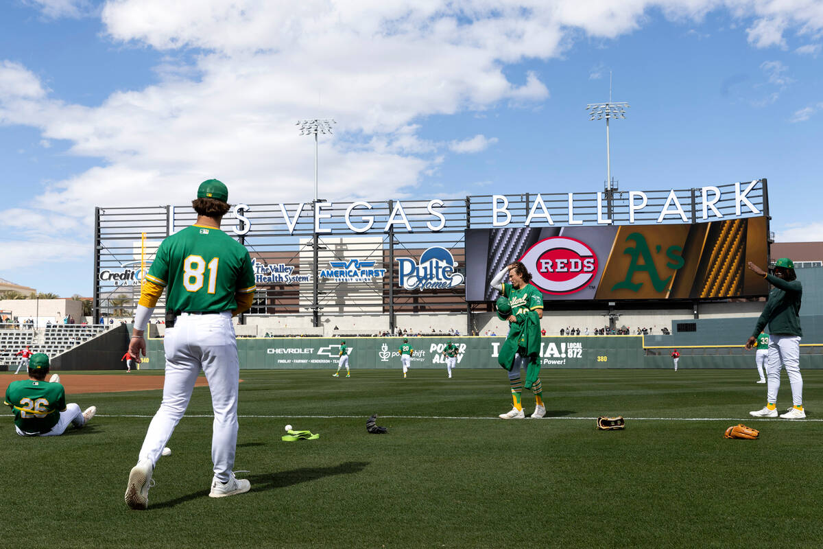 The Oakland Athletics warm up before an MLB exhibition game against the Cincinnati Reds at the ...
