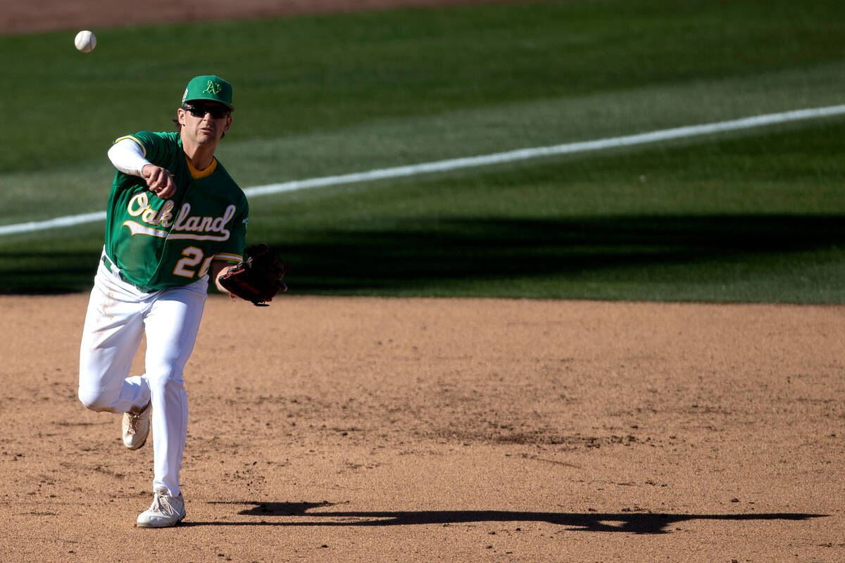Oakland Athletics third baseman Jonah Bride throws to first base in an attempt to out the Cinci ...