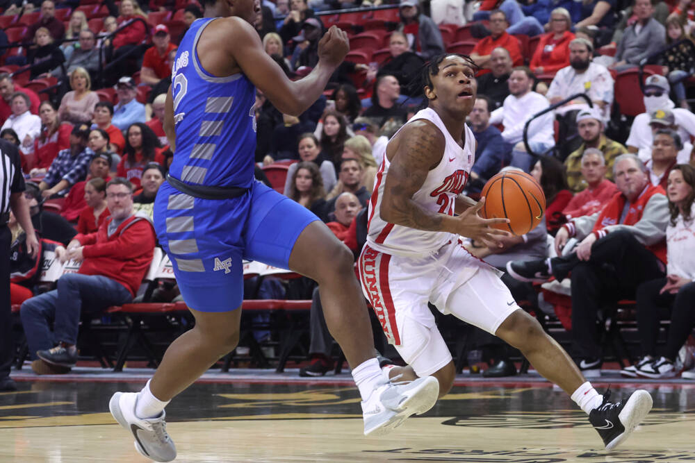 UNLV guard Jackie Johnson III (24) drives to the basket past Air Force Falcons guard Marcell Mc ...