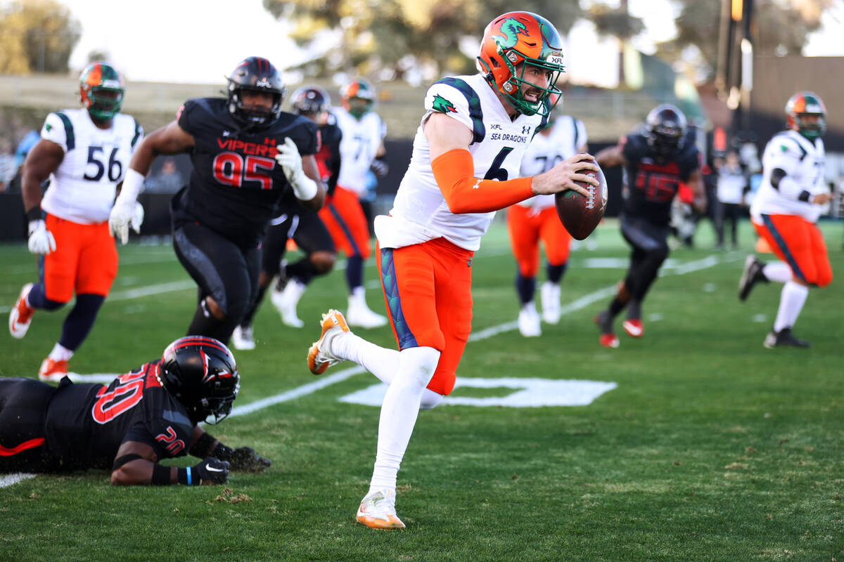 Seattle Sea Dragons quarterback Ben DiNucci (6) runs the ball after dodging a tackle from Vegas ...