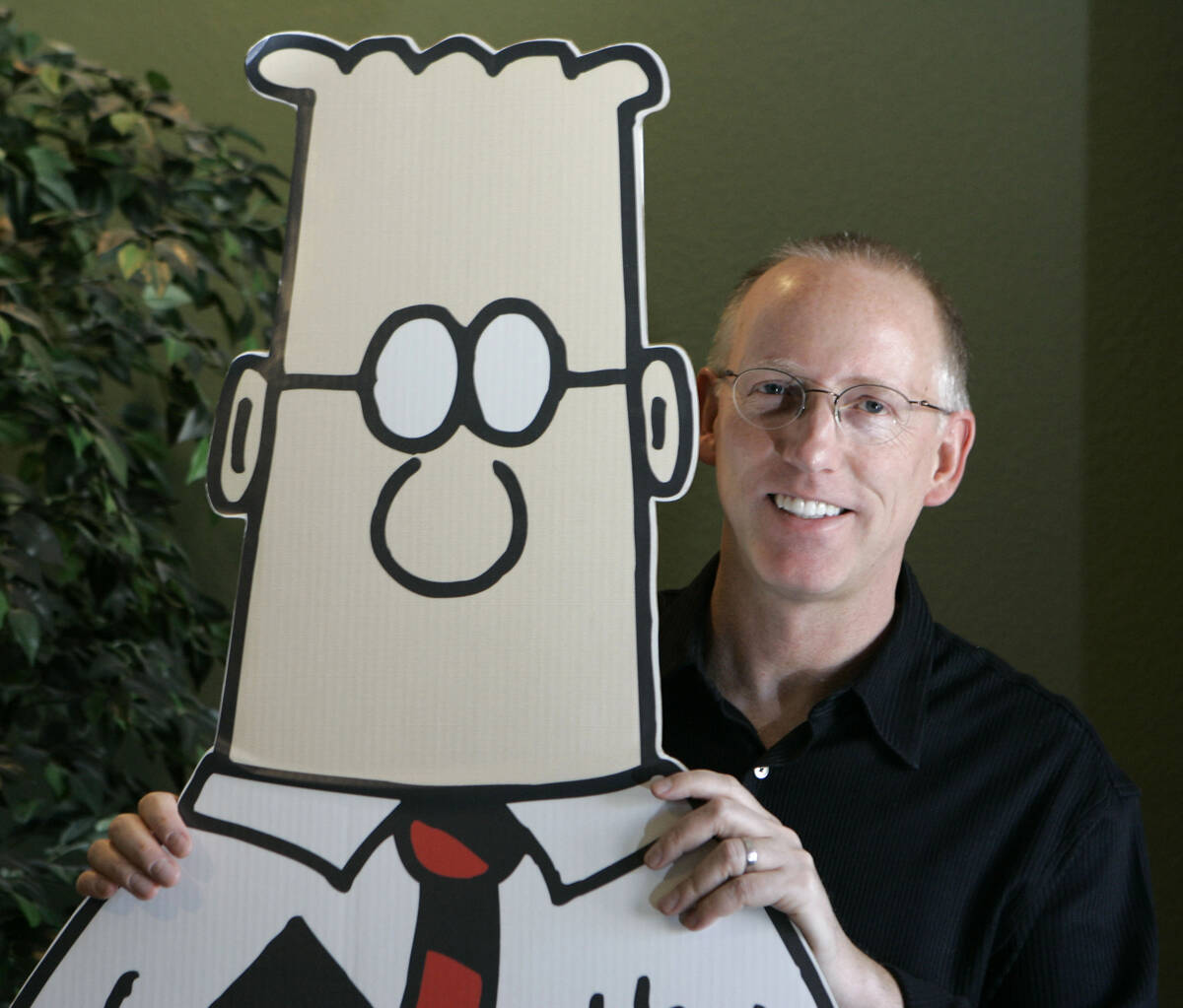 Scott Adams, creator of the comic strip Dilbert, poses for a portrait with the Dilbert characte ...
