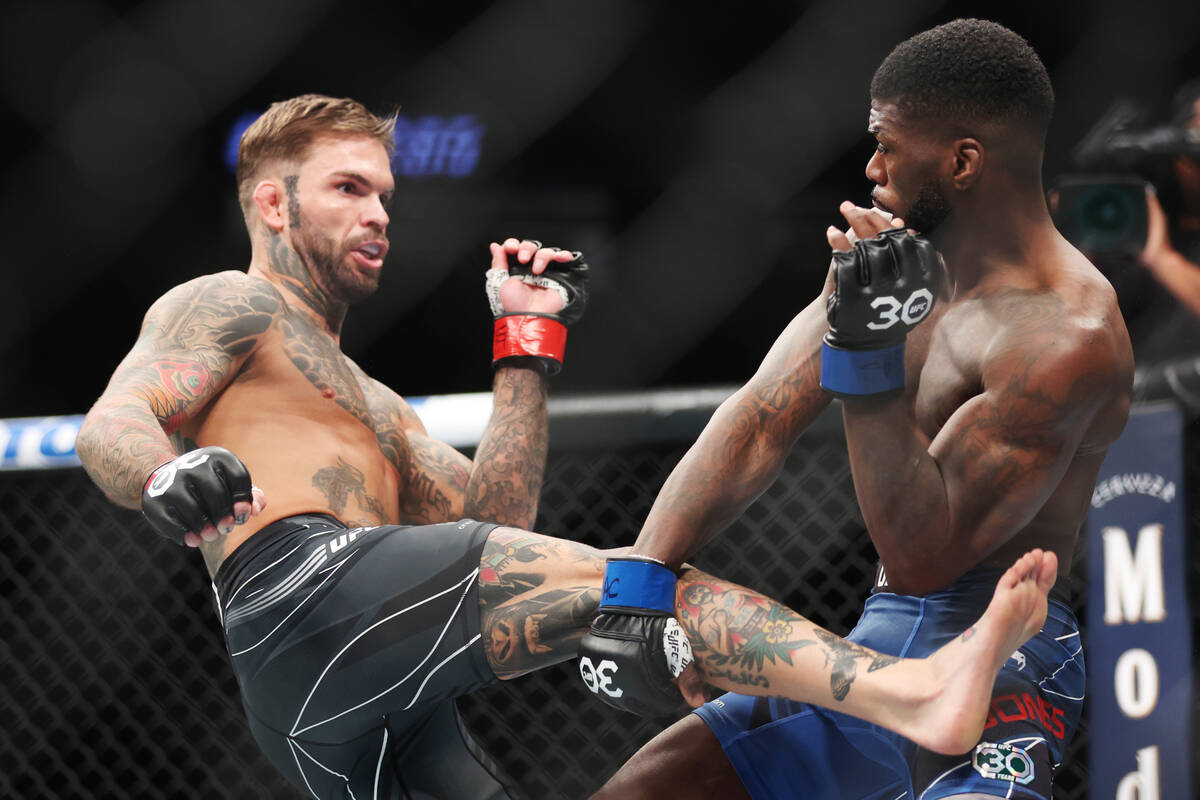 Trevin Jones, right, defends a kick from Cody Garbrandt during a UFC 285 bantamweight fight at ...