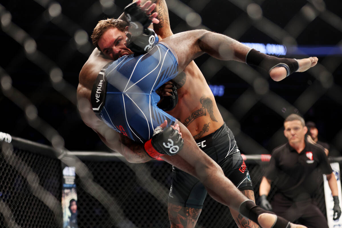 Cody Garbrandt, right, takes down Trevin Jones during a UFC 285 bantamweight fight at T-Mobile ...