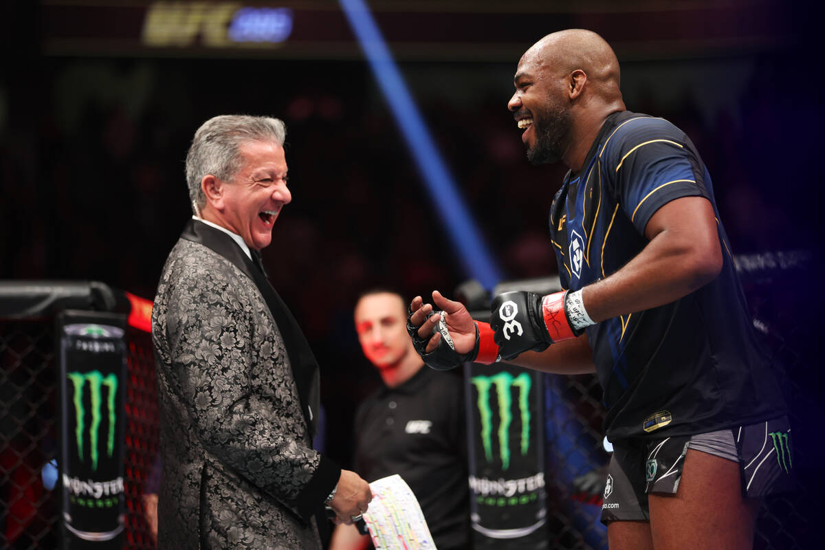 Jon Jones, right, dances with announcer Bruce Buffer, after his submission victory over Ciryl G ...