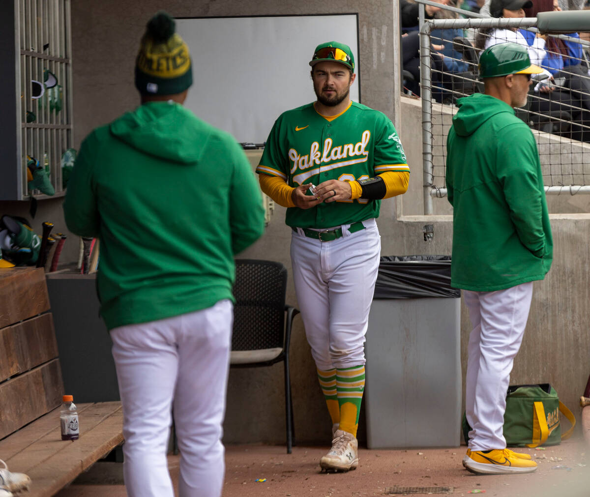Oakland Athletics designated hitter Shea Langeliers (23) walks in the dugout before the third i ...