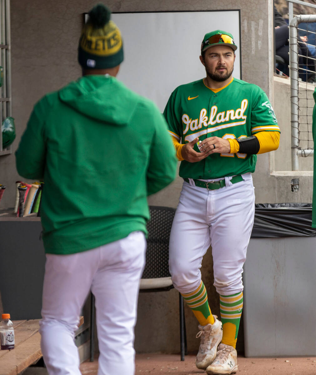 Oakland Athletics designated hitter Shea Langeliers (23) walks in the dugout before the third i ...