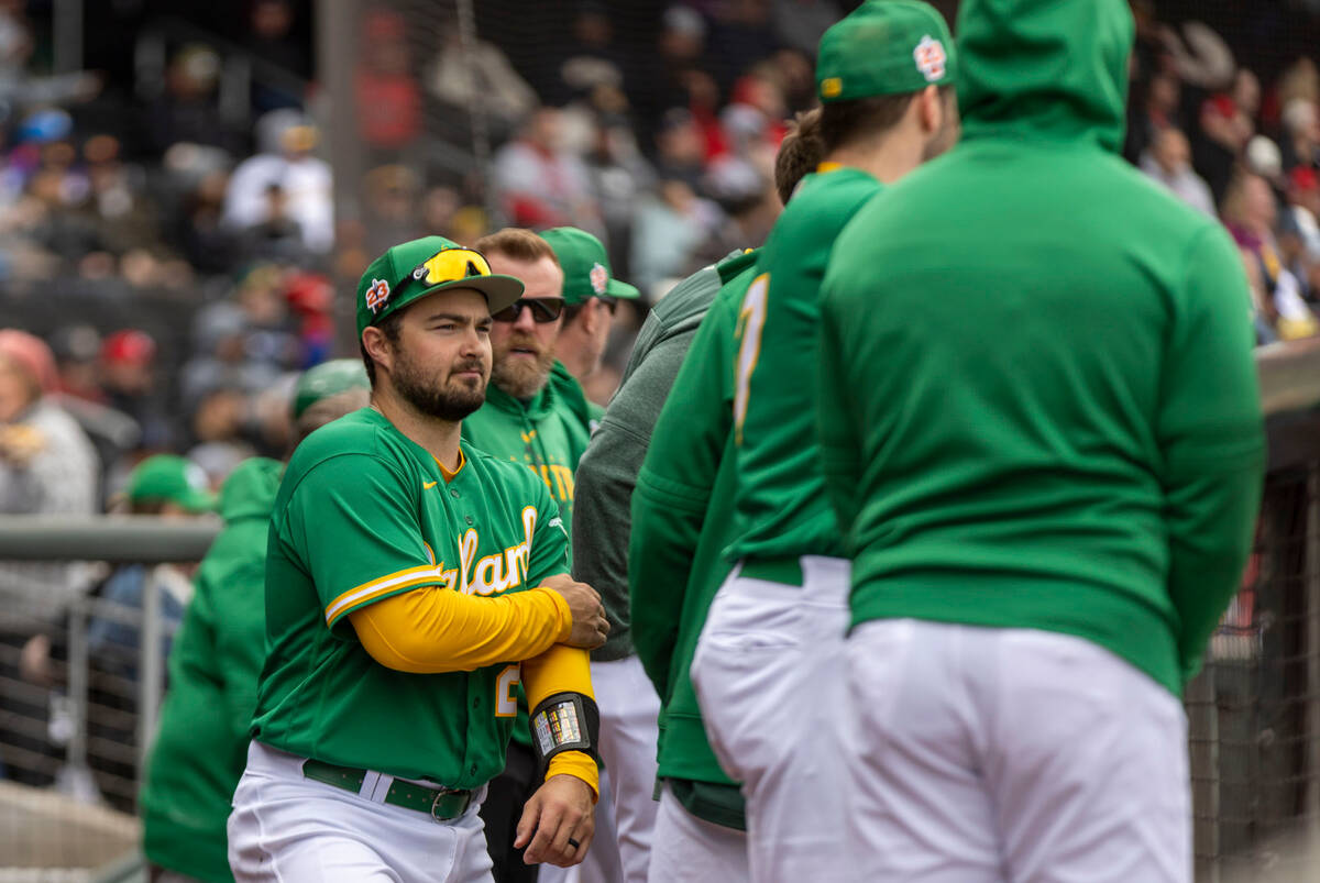 Oakland Athletics designated hitter Shea Langeliers (23) meets with teammates in the dugout dur ...