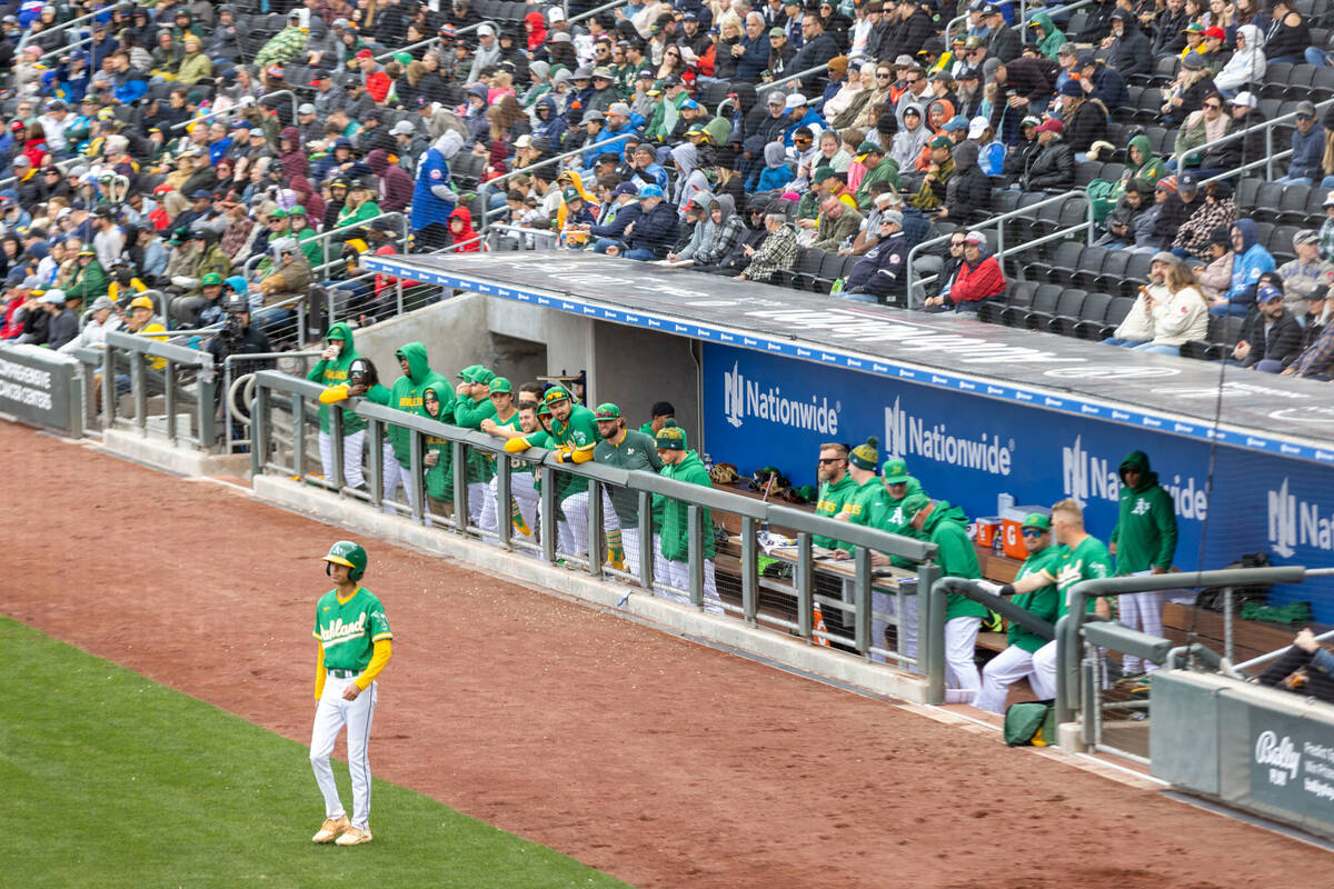 Oakland Athletics watch the team play the Cincinnati Reds from the dugout during the third inni ...