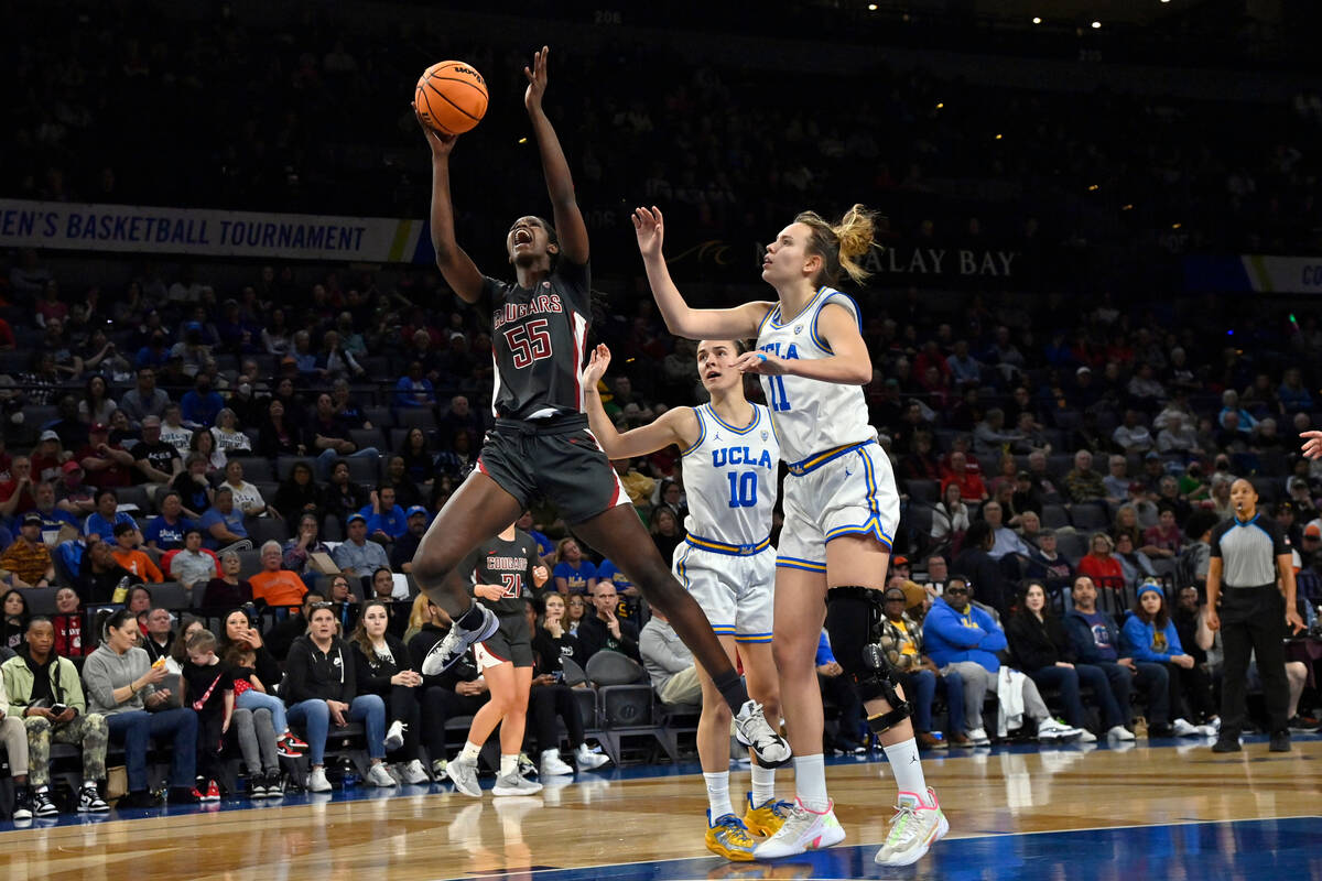 Washington State center Bella Murekatete (55) shoots against UCLA guard Gina Conti (10) and for ...