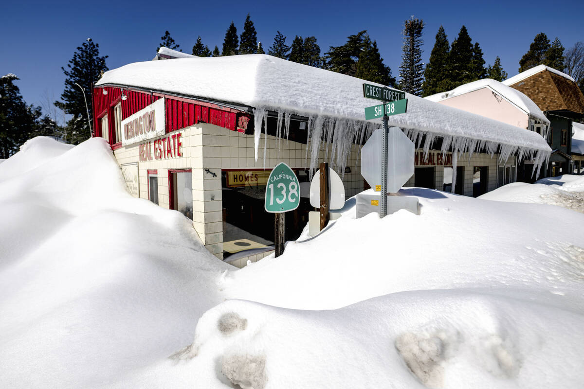 Snowfall surrounds businesses in Crestline, Calif., Friday, March 3, 2023. (Watchara Phomicinda ...