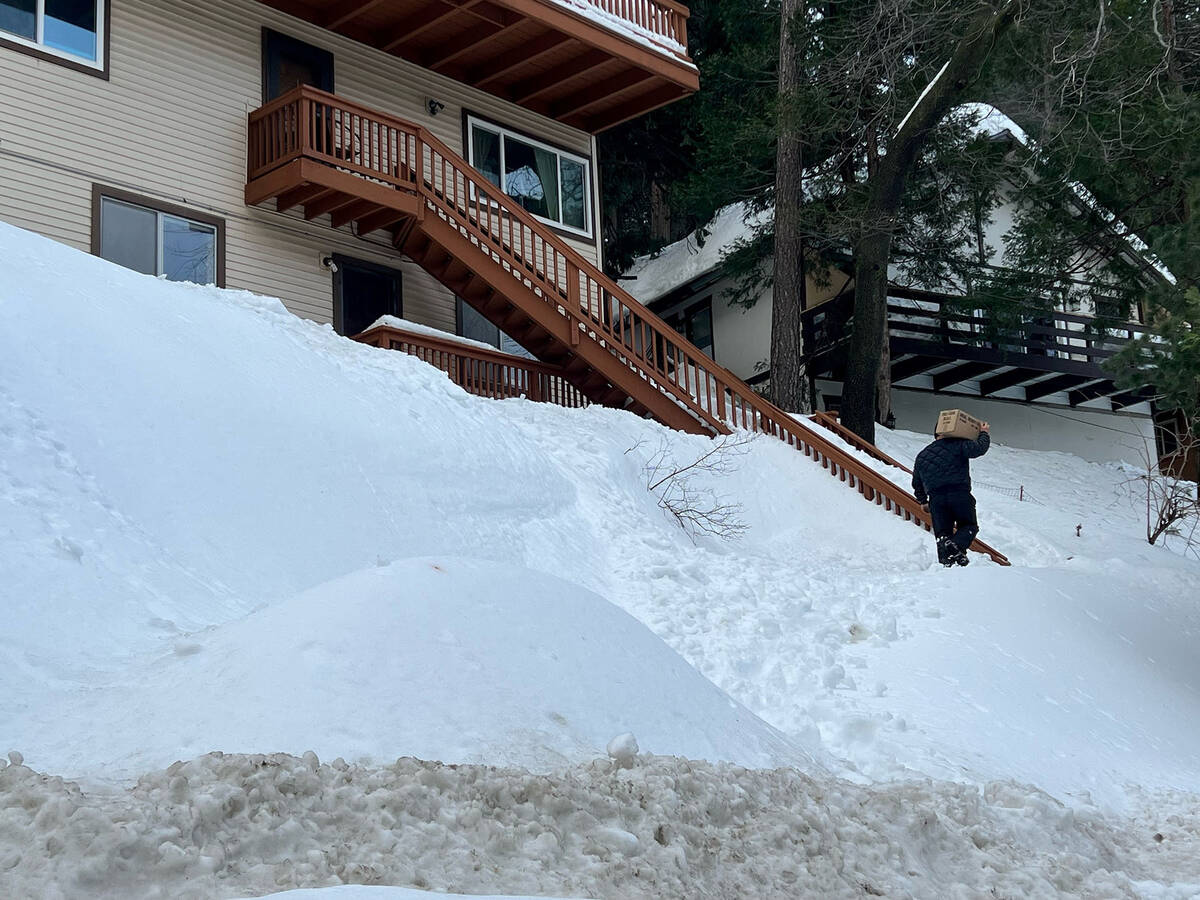 San Bernardino County crews try to reconnect utilities for residents hit by snowstorms over the ...