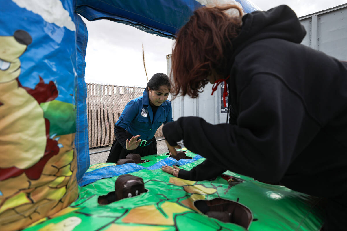 Maggie Shima, 9, left, plays a game with Zoe Shakerchi, 18, right, at a parade for the Jewish h ...