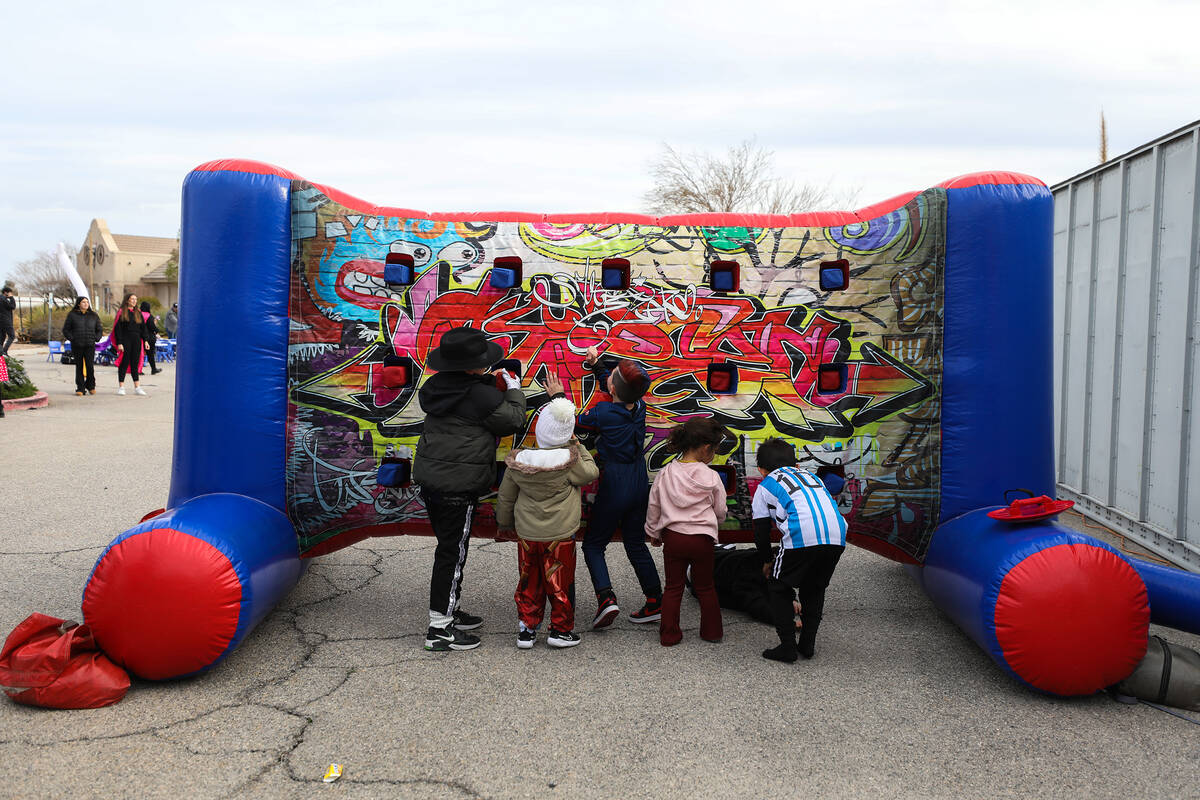 Kids play a game at a parade for the Jewish holiday of Purim hosted by the Israeli American Cou ...