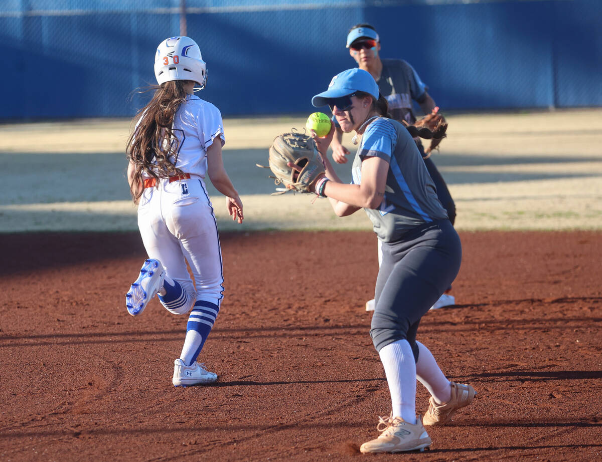 Centennial's Juliana Bosco, right, looks to pass to first base for an out during a softball gam ...