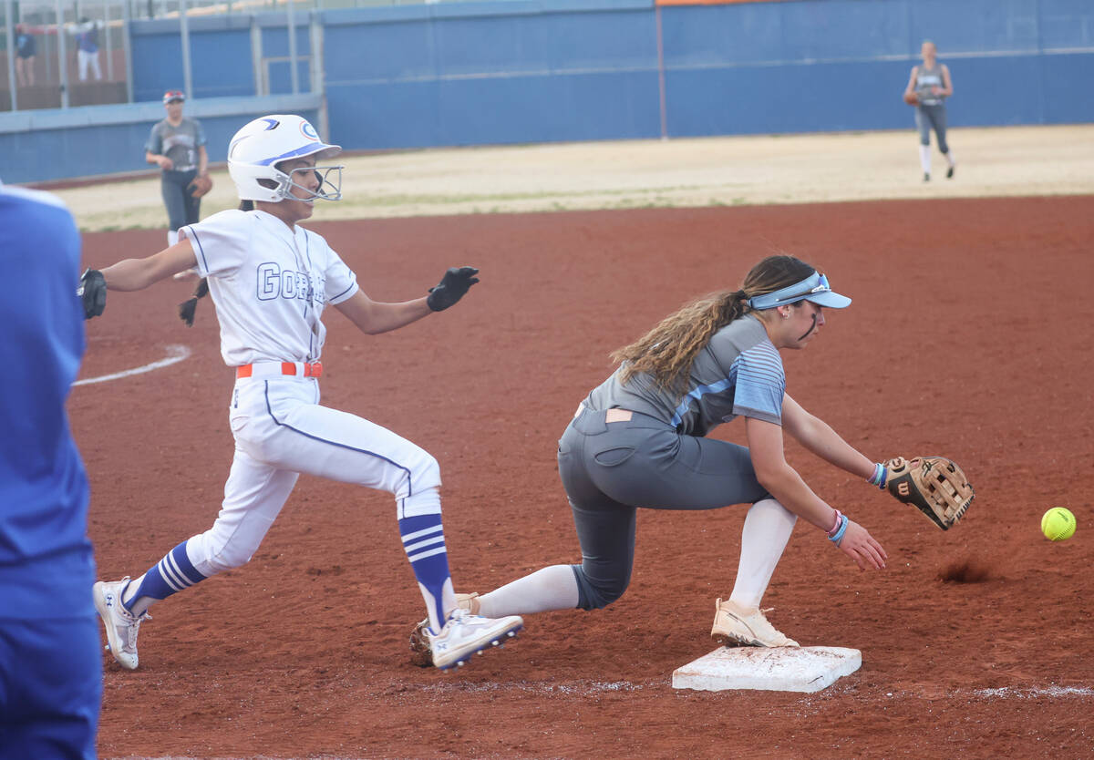 Bishop Gorman’s Brooklen Hicks, left, makes it to first base as Centennial's Carmella Ko ...