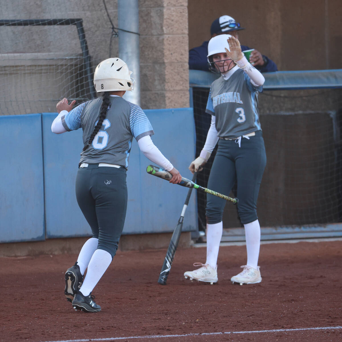 Centennial's Leeah Ibarra (6) celebrates her run with Ashley Madonia (3) during a softball game ...