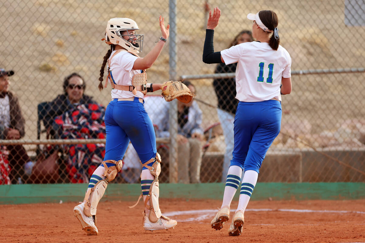 Green Valley's Rustie Riley (14) and Avari Morris (11) high five after ending the inning during ...