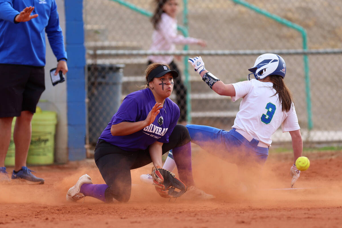 Green Valley's Lauryn Galvin (3) slides to third base safely as Silverado's LeAnna Cortez (10) ...