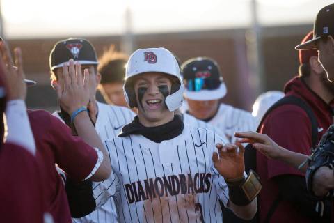Desert Oasis’ Jake Cook, center, gets a high-five from his teammates after scoring durin ...