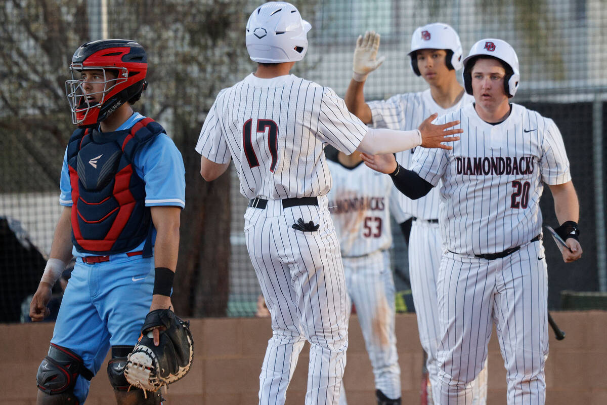 Desert Oasis’ Noah Griffith (17) and his teammate Ethan Kelly (20) high-five after the b ...