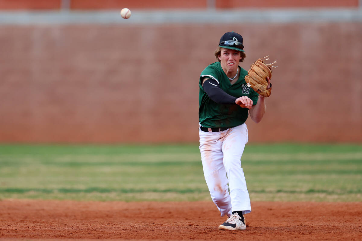 Palo Verde's Branson Pullan (23) throws the ball to first base for an out against Legacy during ...