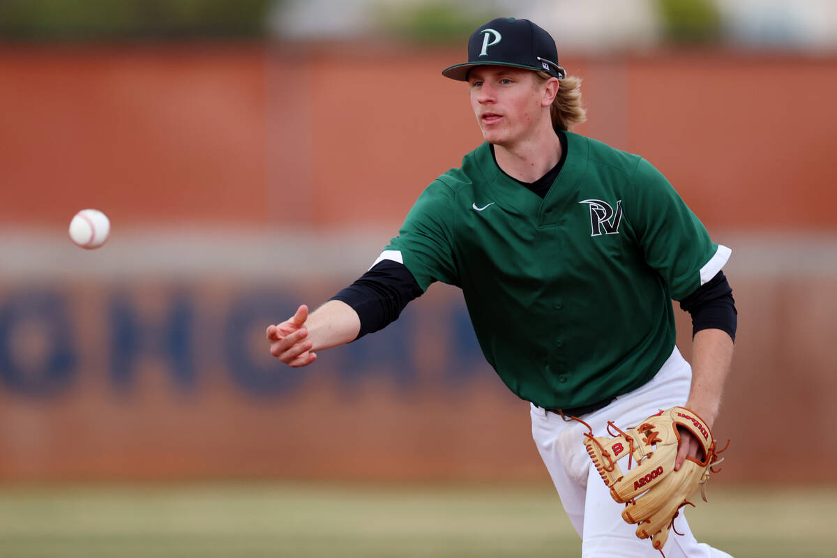 Palo Verde's Kody Bialas (12) throws the ball to first base for an out against Legacy during a ...