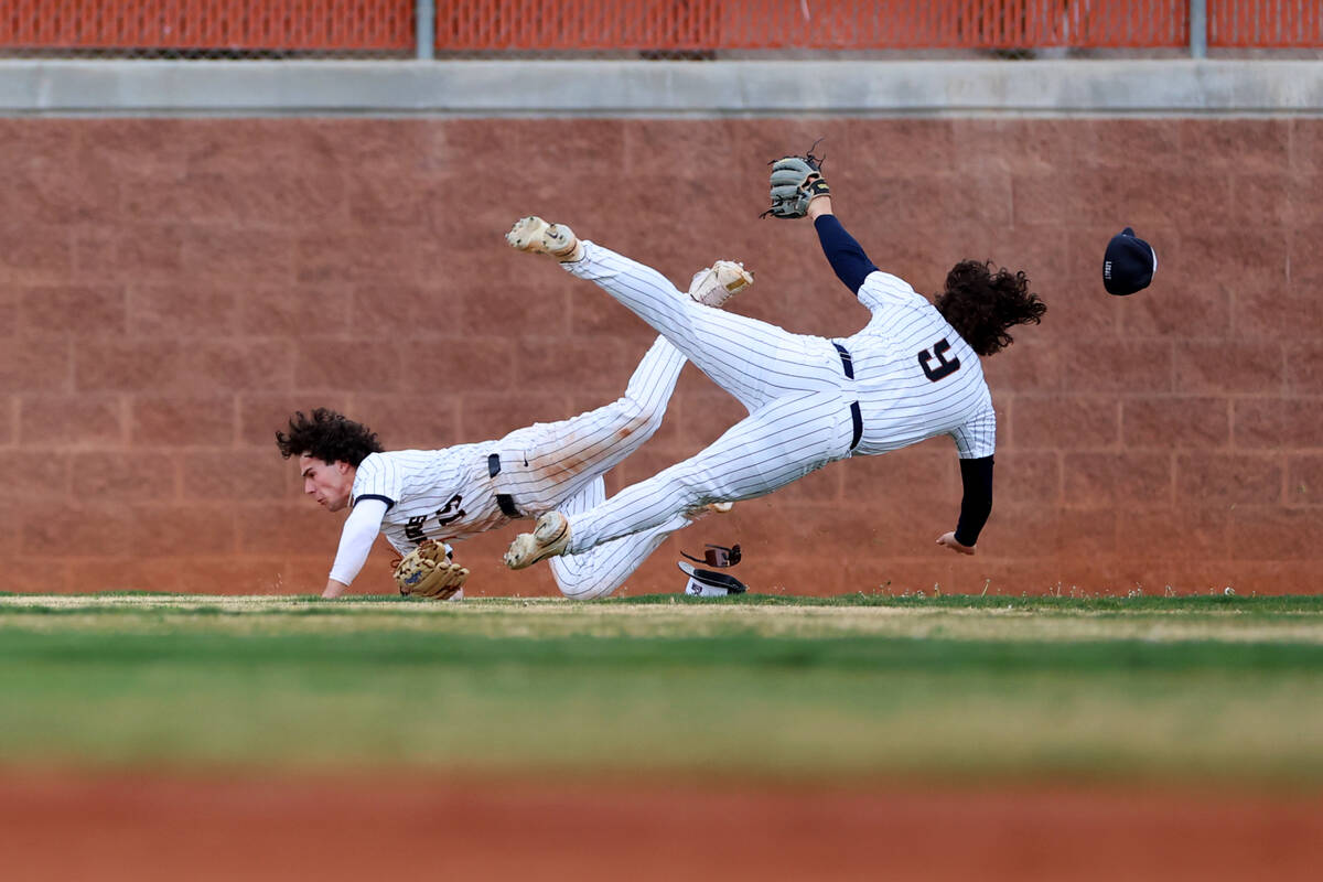 Legacy's Colton Stanton (15) makes a catch for an out before colliding with his teammate Joshua ...